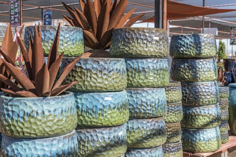 Stacked blue-green hammered glazed pots at Desert Horizon Nursery
